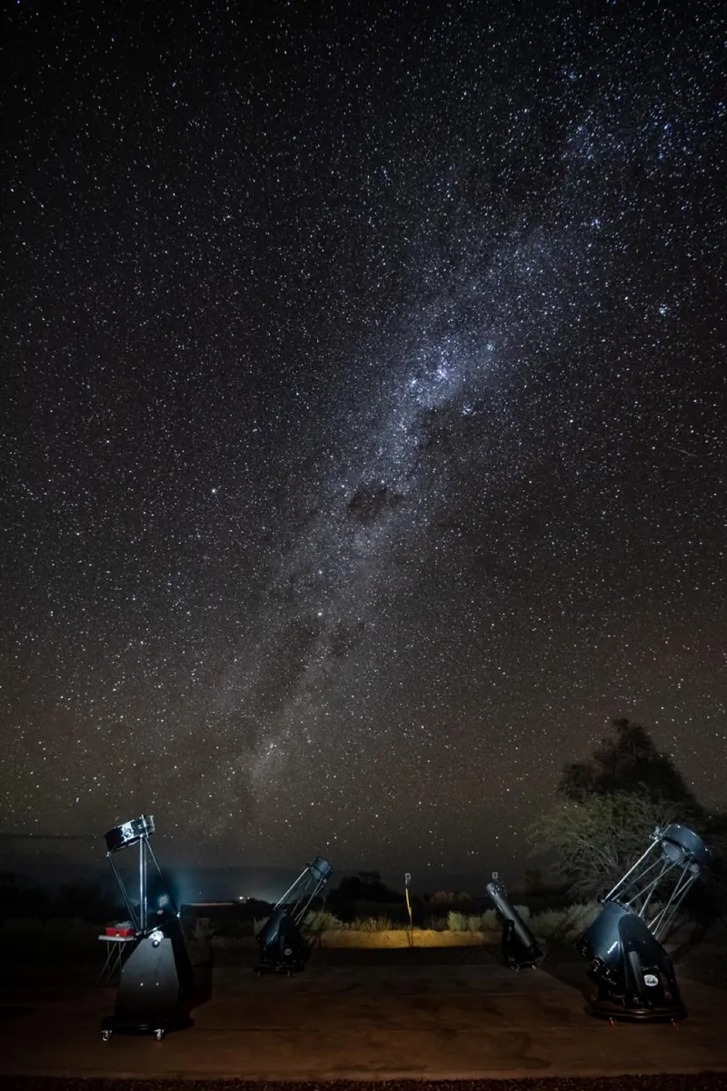 Cuatro telescopios apuntando al cielo nocturno en el observatorio de Atacama